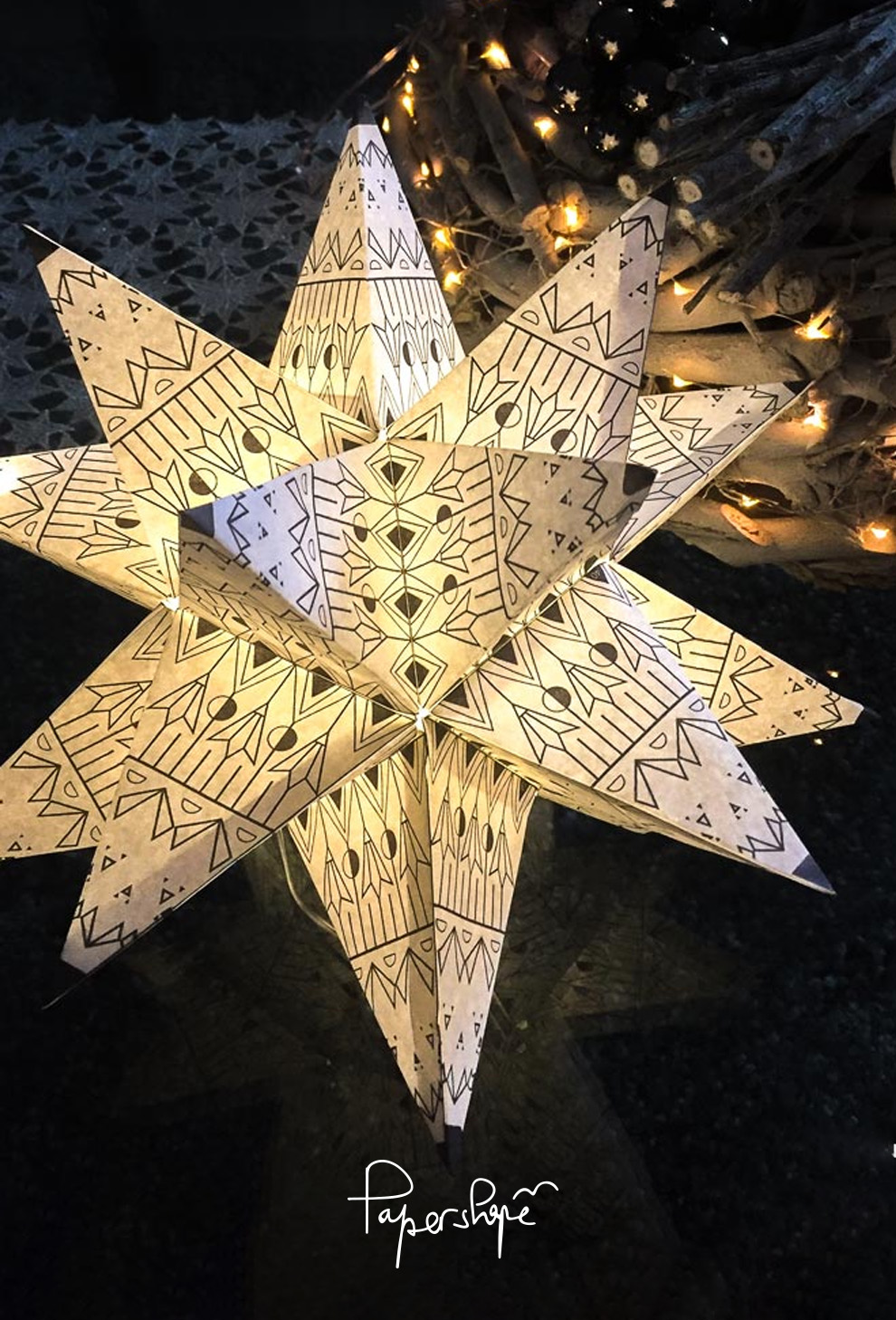 Handmade, glowing 3D paper star with geometric pattern, Christmas decoration by Papershape, atmospherically illuminated in the dark