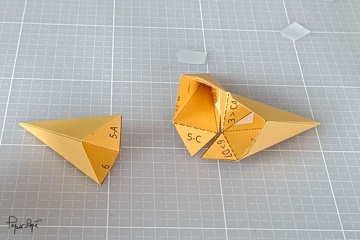 Two folded star pieces are joined together to form the 3D Christmas star