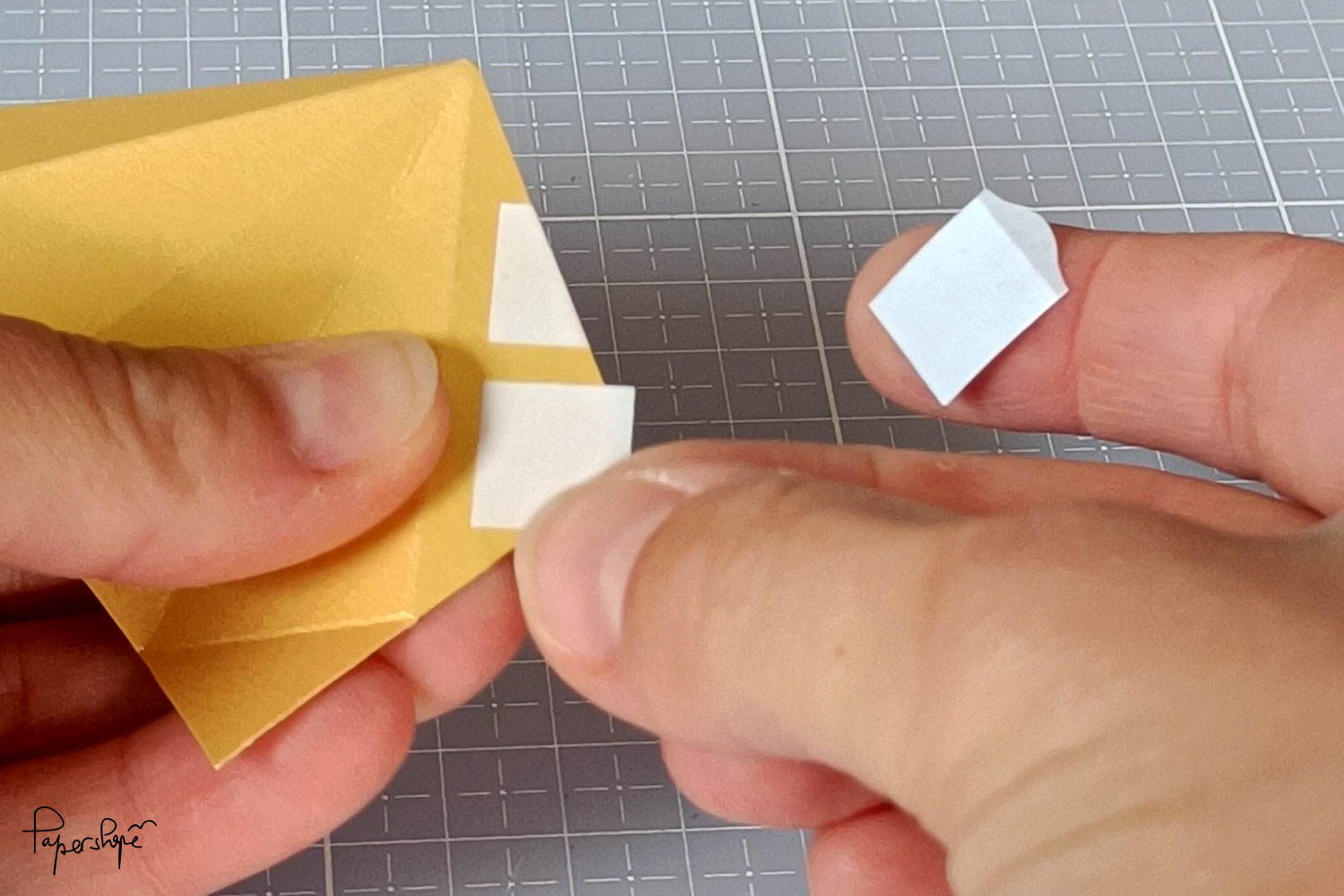 The adhesive pads are folded over at the tips