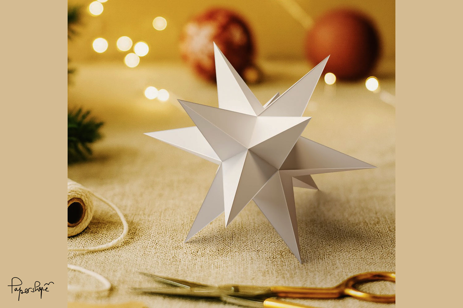 Ready-made Christmas star with 12 points made of paper as a Christmas decoration on the table with craft materials