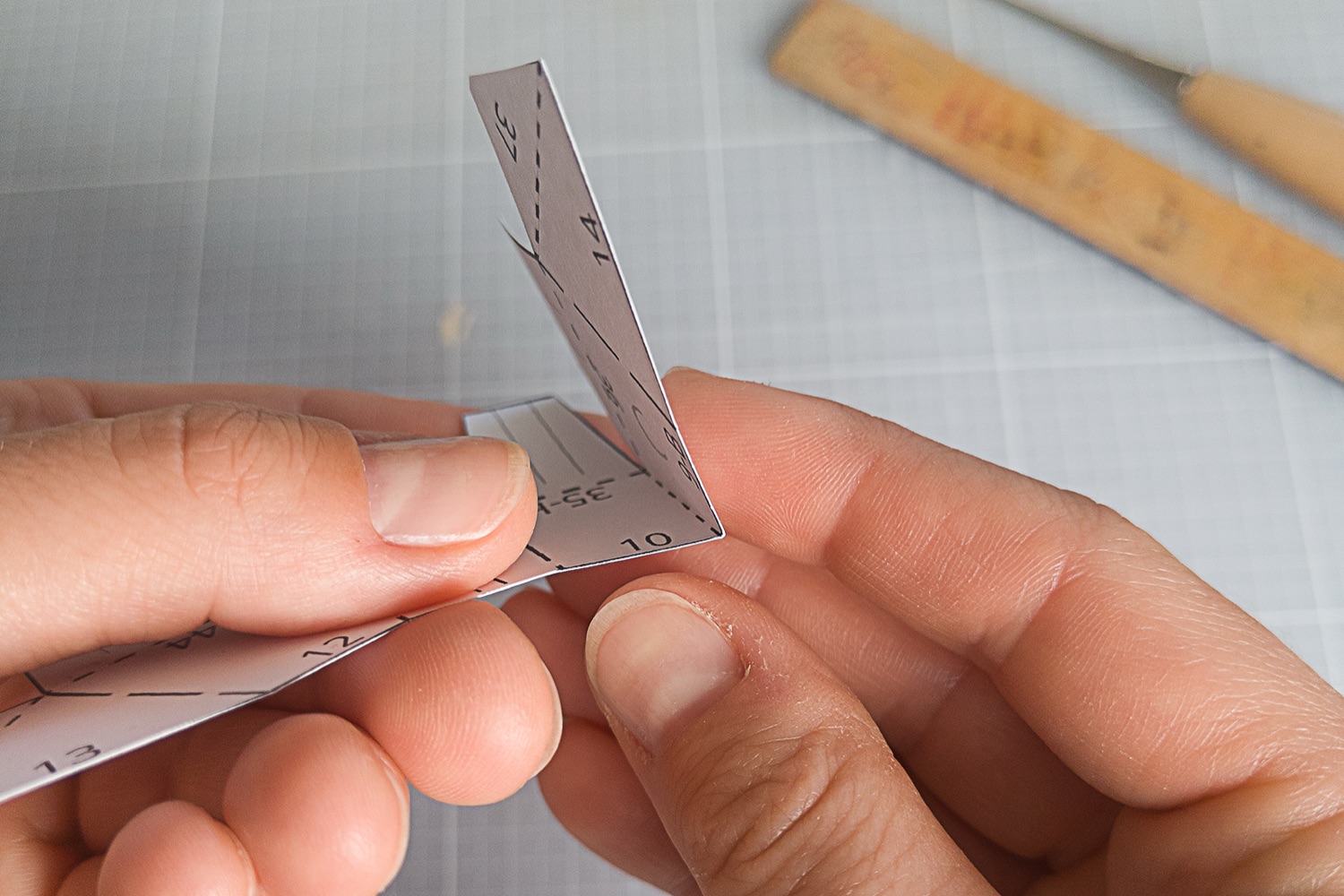 Folding a numbered Westie paper part along the fold line