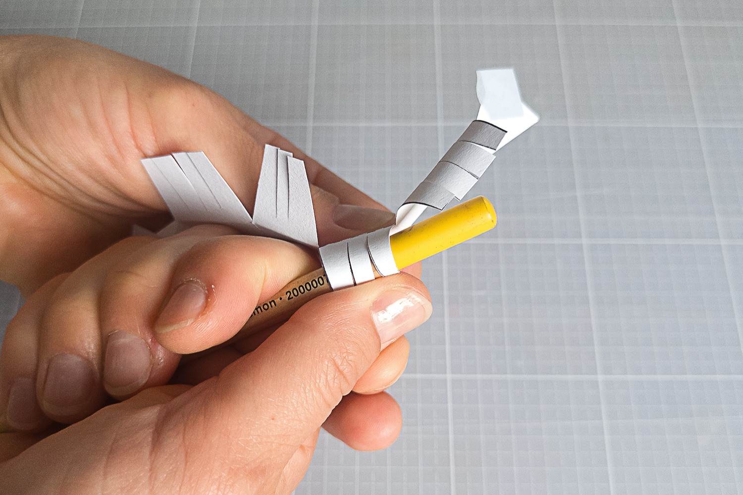 Curling the Westie’s paper fringes around a pencil