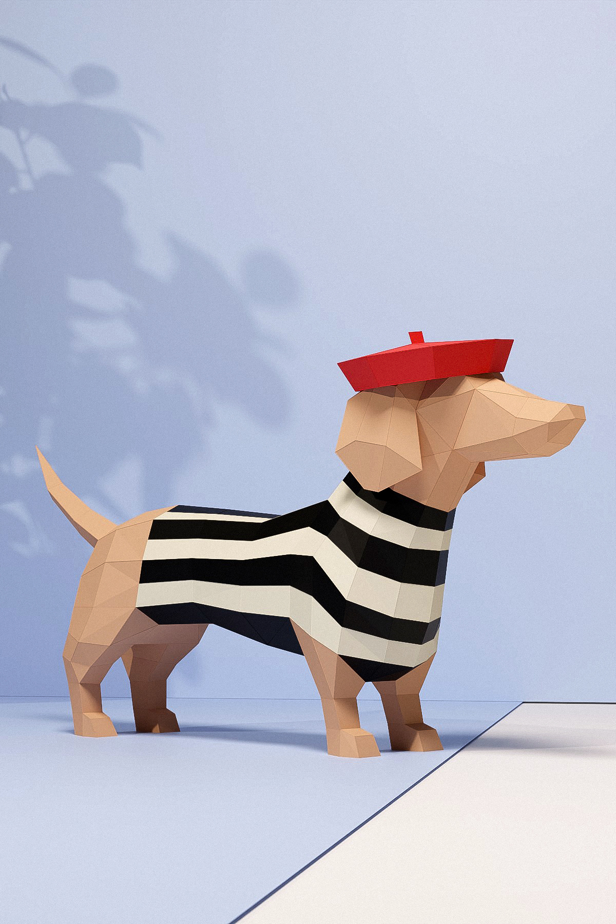 3D papercraft dachshund "Colette" made of light brown cardstock with a black and white striped shirt and a red beret, standing in profile facing right against a light blue wall with plant shadows.