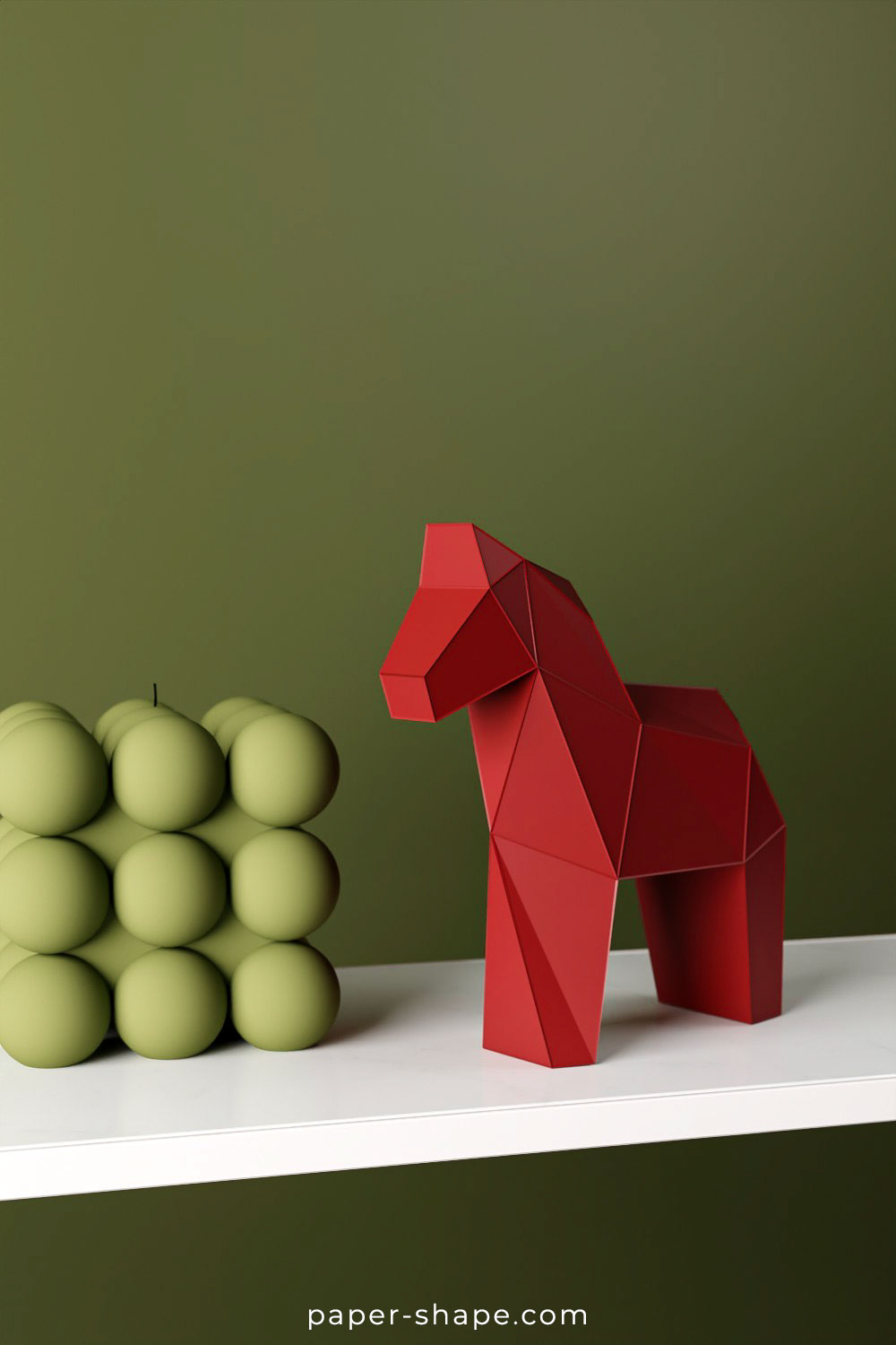 Red paper low poly Dala horse against green wall