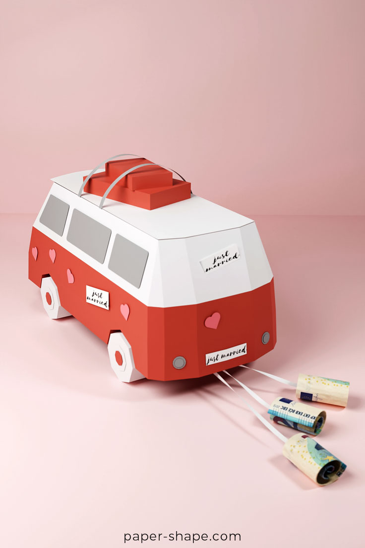 Crafted paper wedding bus with decorated hearts and rolled up banknotes as cans
